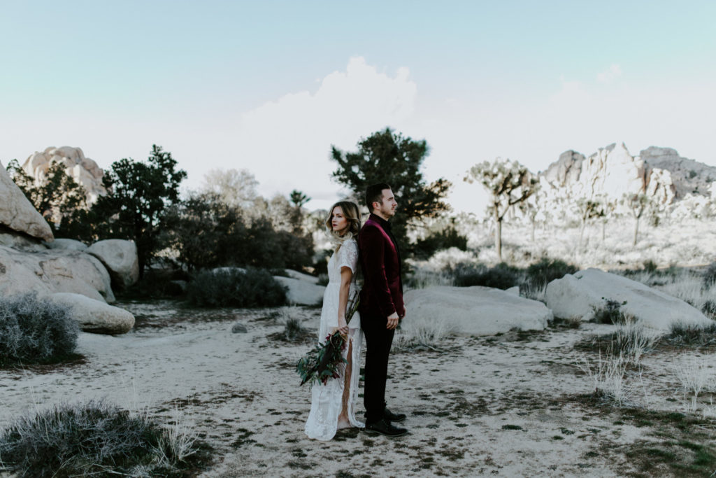 Jeremy and Alyssa stand back to back in Joshua Tree National Park.