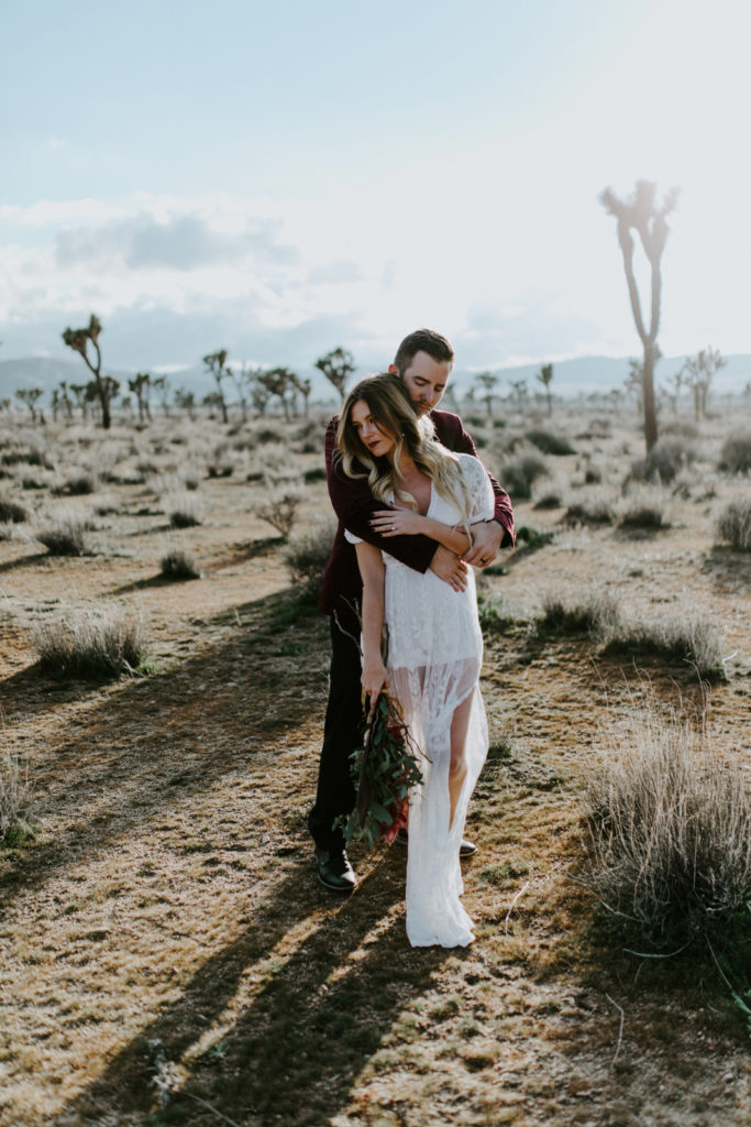 Jeremy holds Alyssa after their elopement ceremony in Joshua  Tree National Park.