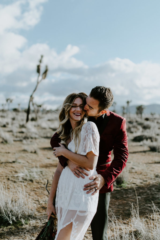 Jeremy holds and kisses Alyssa after their ceremony in Joshua Tree National Park.