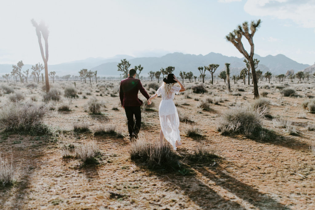 Alyssa and Jeremy walk into the dessert in Joshua Tree National Park.