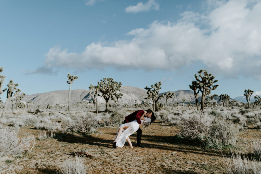 Jeremy dips Alyssa after their elopement ceremony in Joshua Tree National Park.