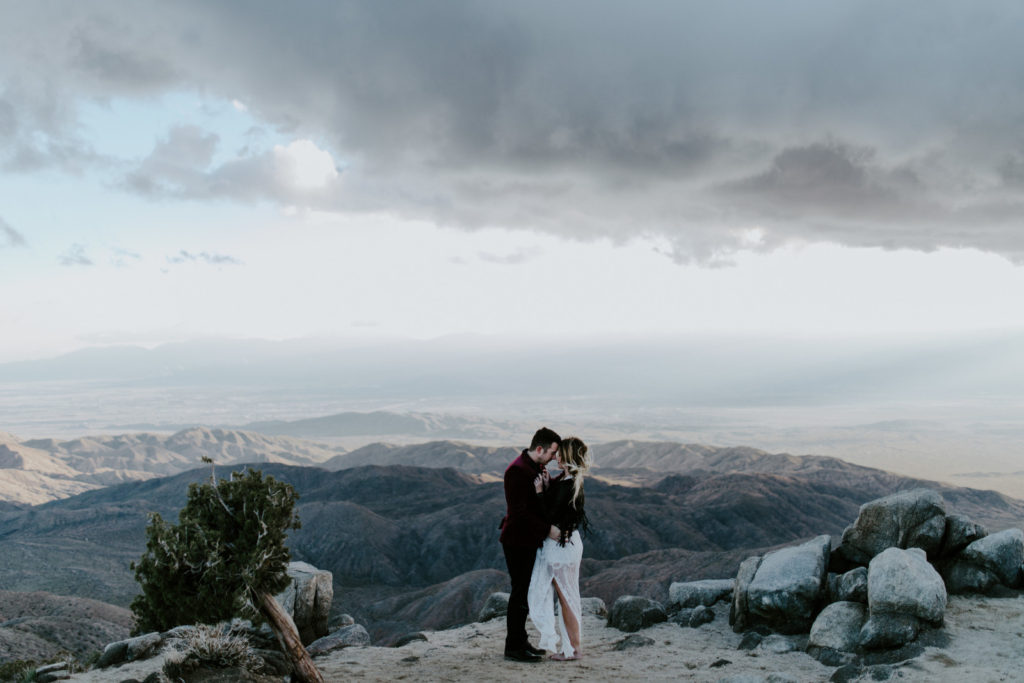 Jeremy and Alyssa stand in front of Keys Point in Joshua Tree National Park after their elopement ceremony.