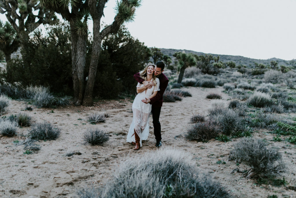 Jeremy hugs Alyssa in the desert of Joshua Tree National Park after their elopement.