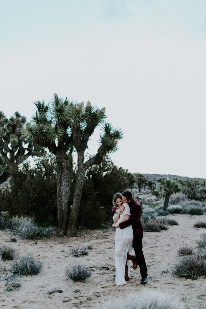 Jeremy hugs Alyssa in Joshua Tree National Park after their elopement ceremony.