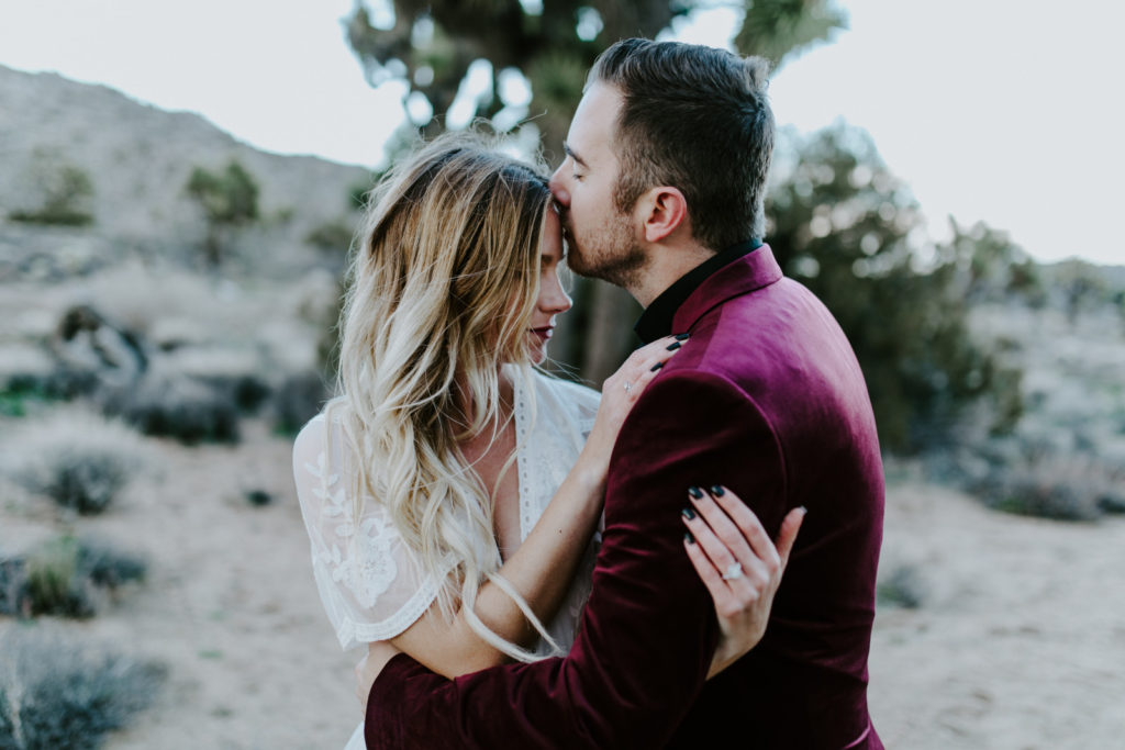 Jeremy kisses Alyssa's forehead after elopement ceremony in Joshua Tree National Park.