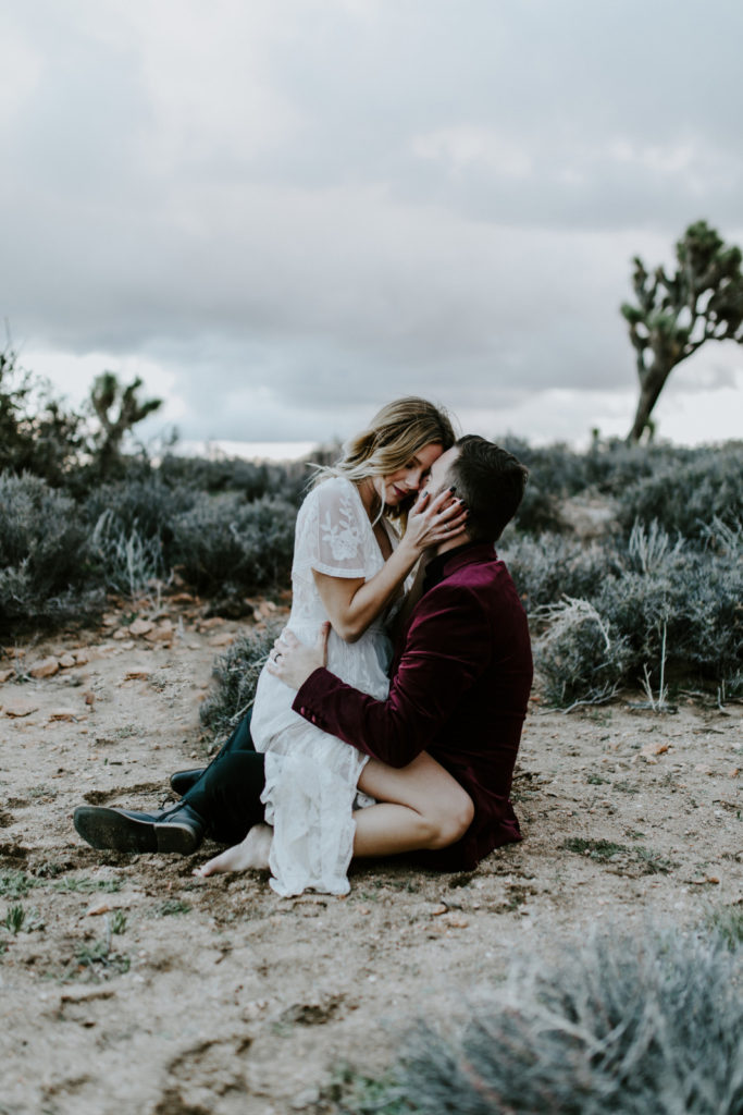 Alyssa and Jeremy go in for a kiss in Joshua Tree National Park.