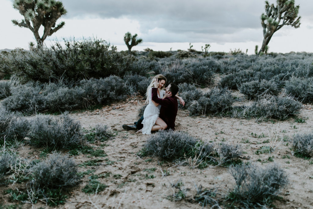 Jeremy and Alyssa share a moment while sitting in the sand at Joshua Tree National Park.