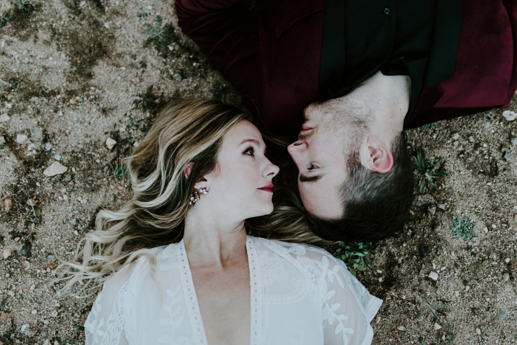 Jeremy and Alyssa lay in the sand in Joshua Tree National Park.