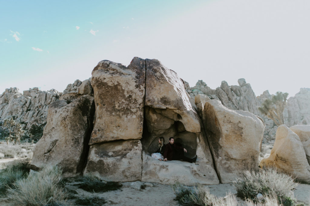 Alyssa and Jeremy sit in the rocks of Joshua Tree National Park.