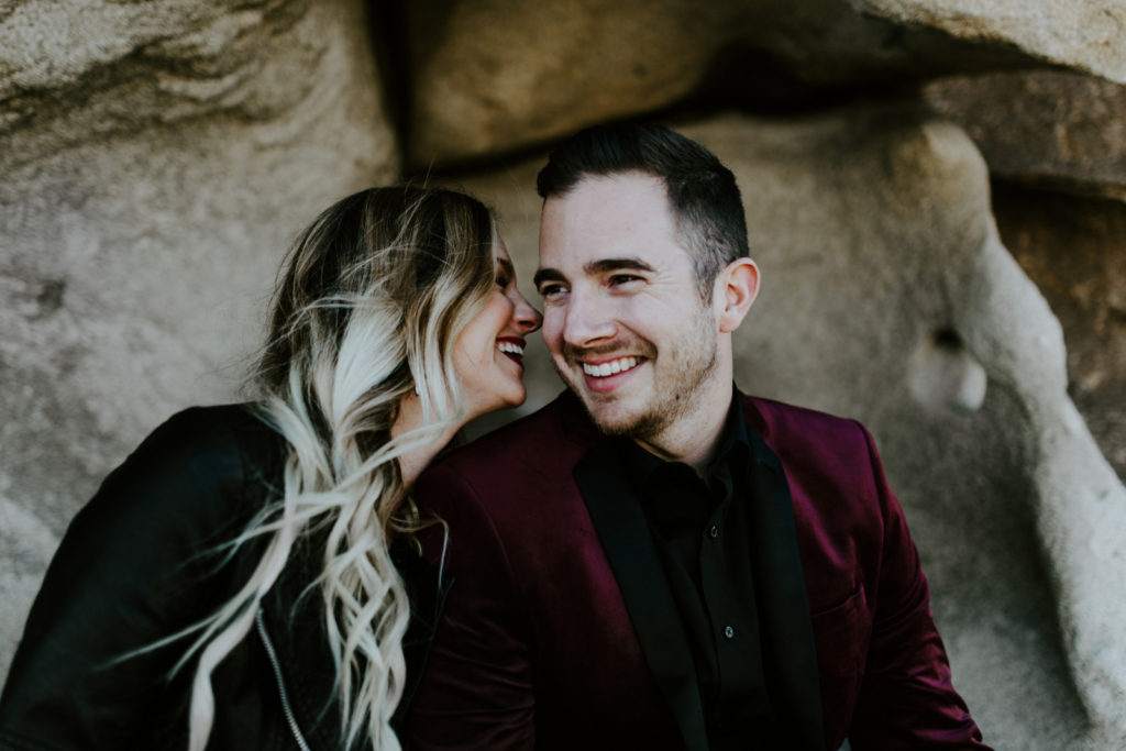 Jeremy and Alyssa smile while sitting in Joshua Tree National Park.